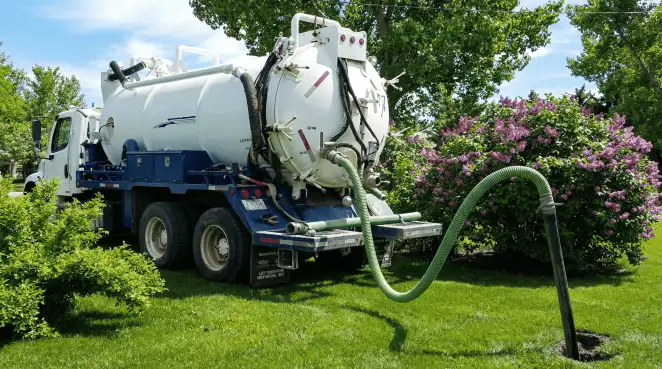 Professional vacuum truck performing residential drainage and septic maintenance in Fresno, CA