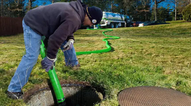 Service technician performing residential septic pumping and drainage maintenance in Fresno, CA